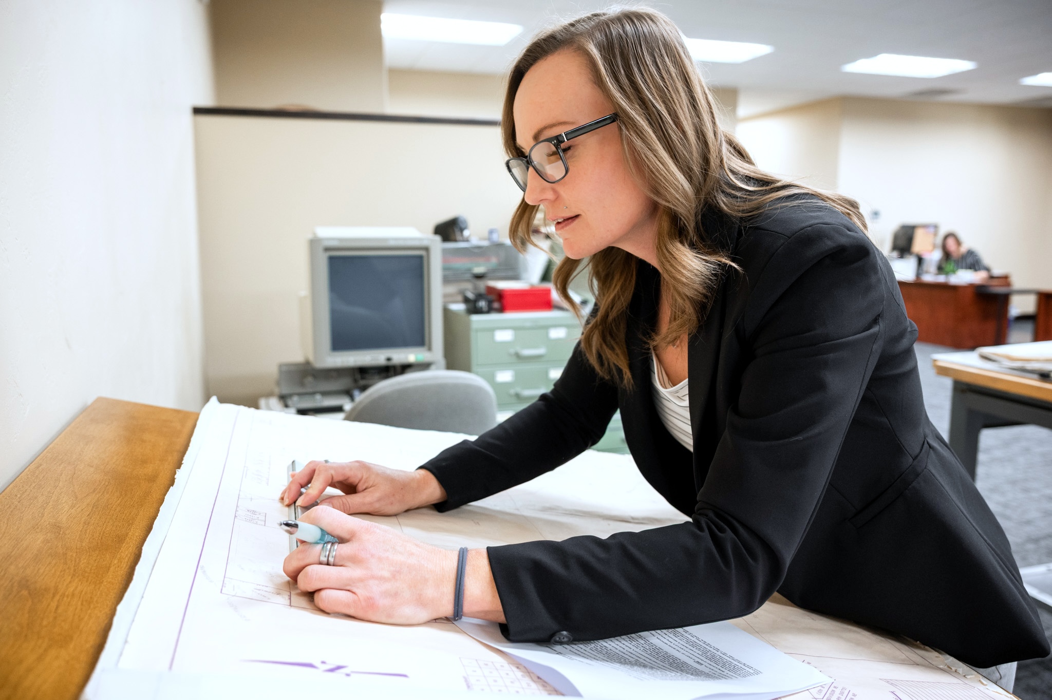 Stock -43 Woman examining a plat map
